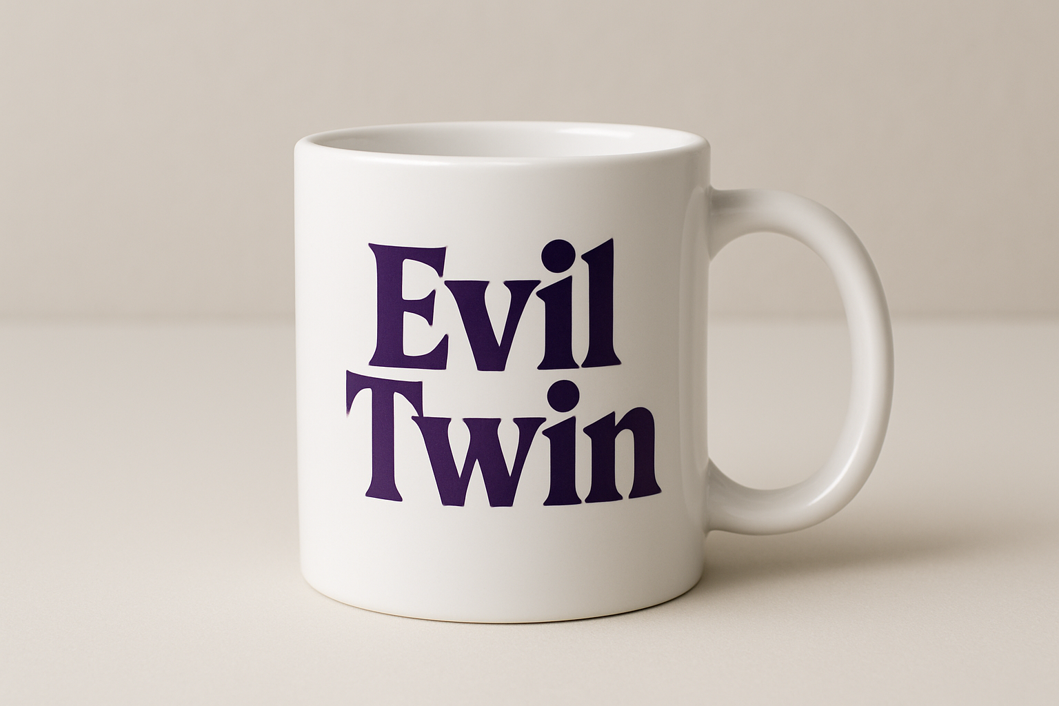 white coffee mug with the words "Evil Twin" in dark purple